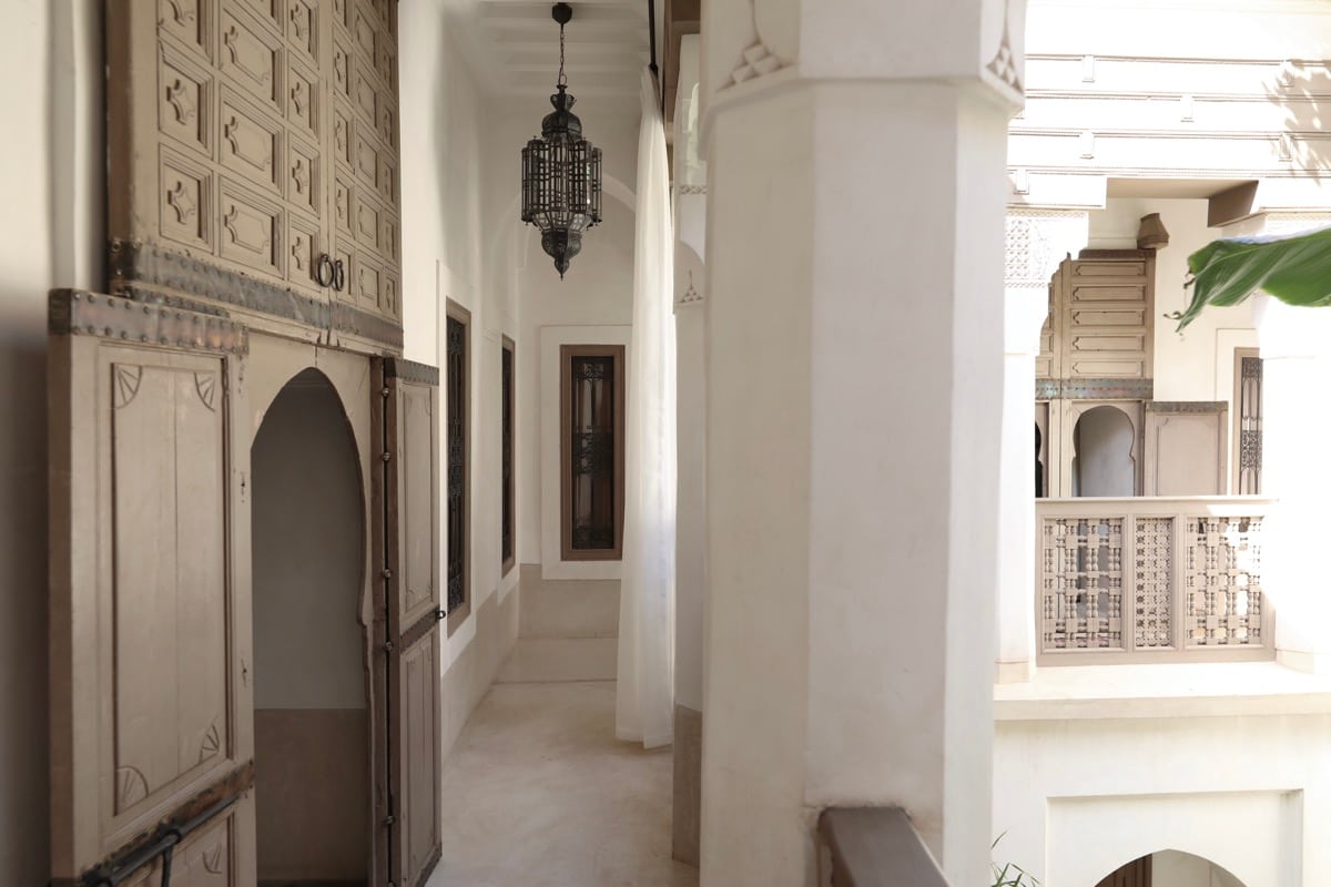 Carved plasterwork, cedar doors and white columns along the gallery