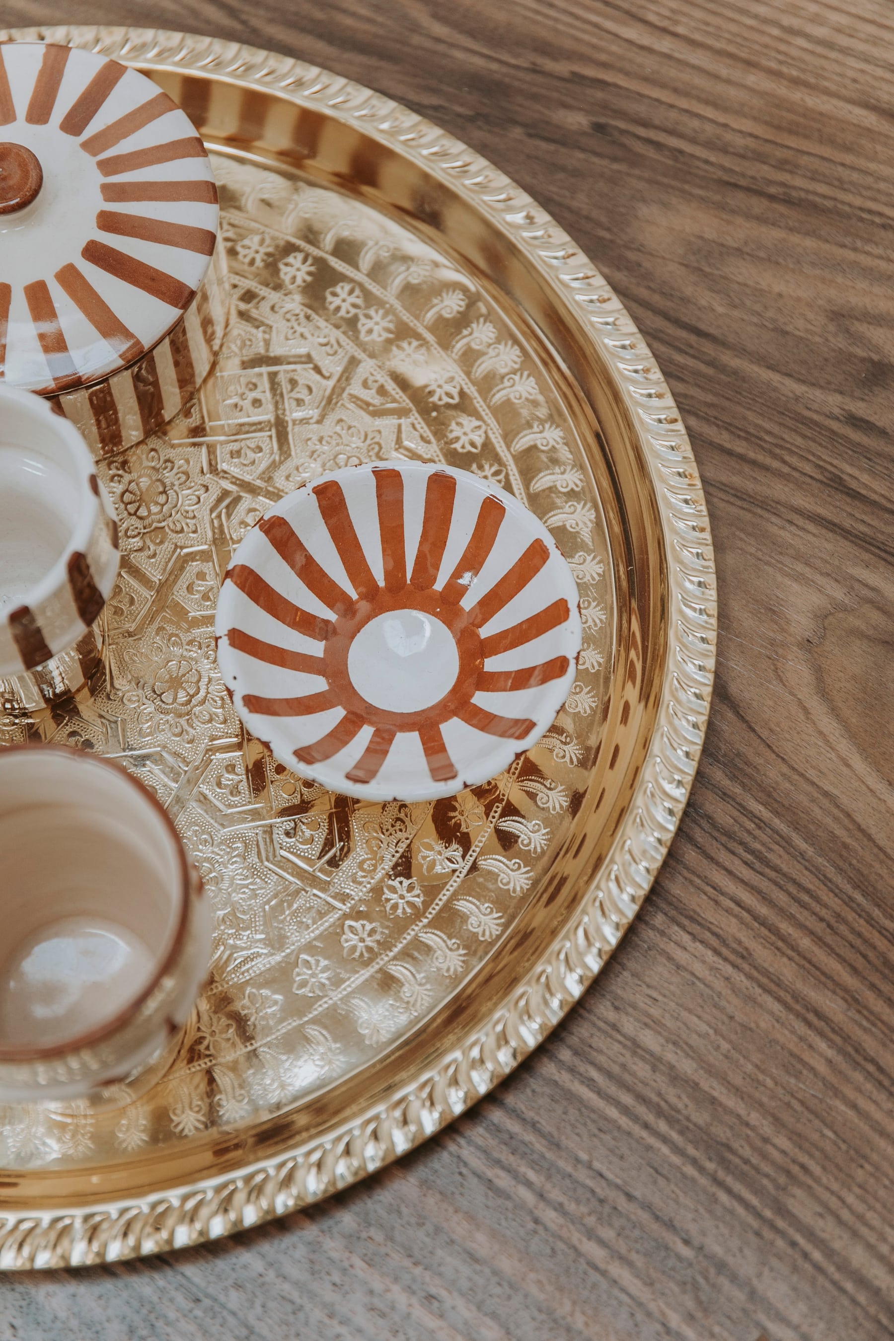 A hand-painted metal tray with sun motifs