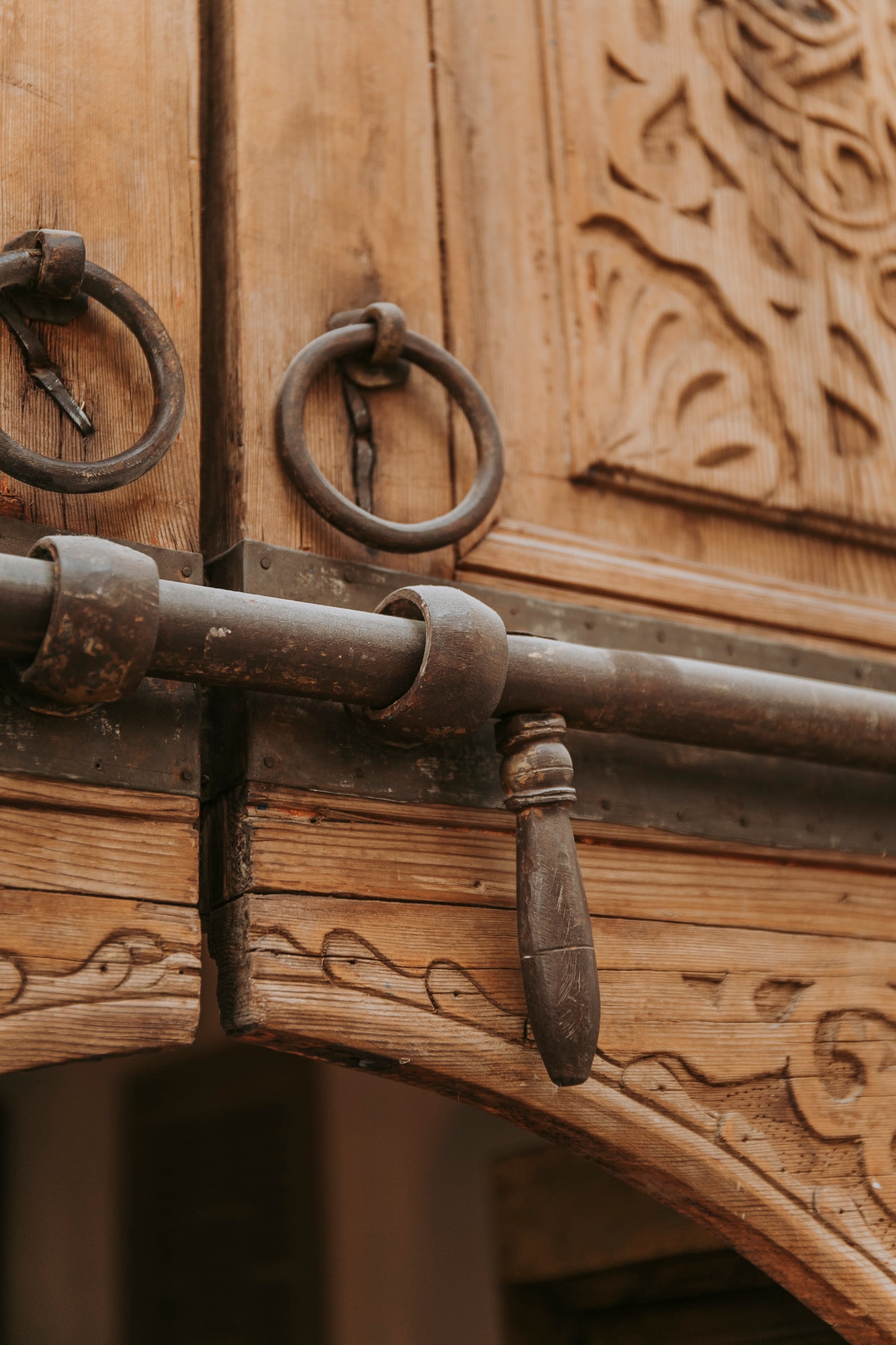 The iron rings and old lock of a carved cedar door