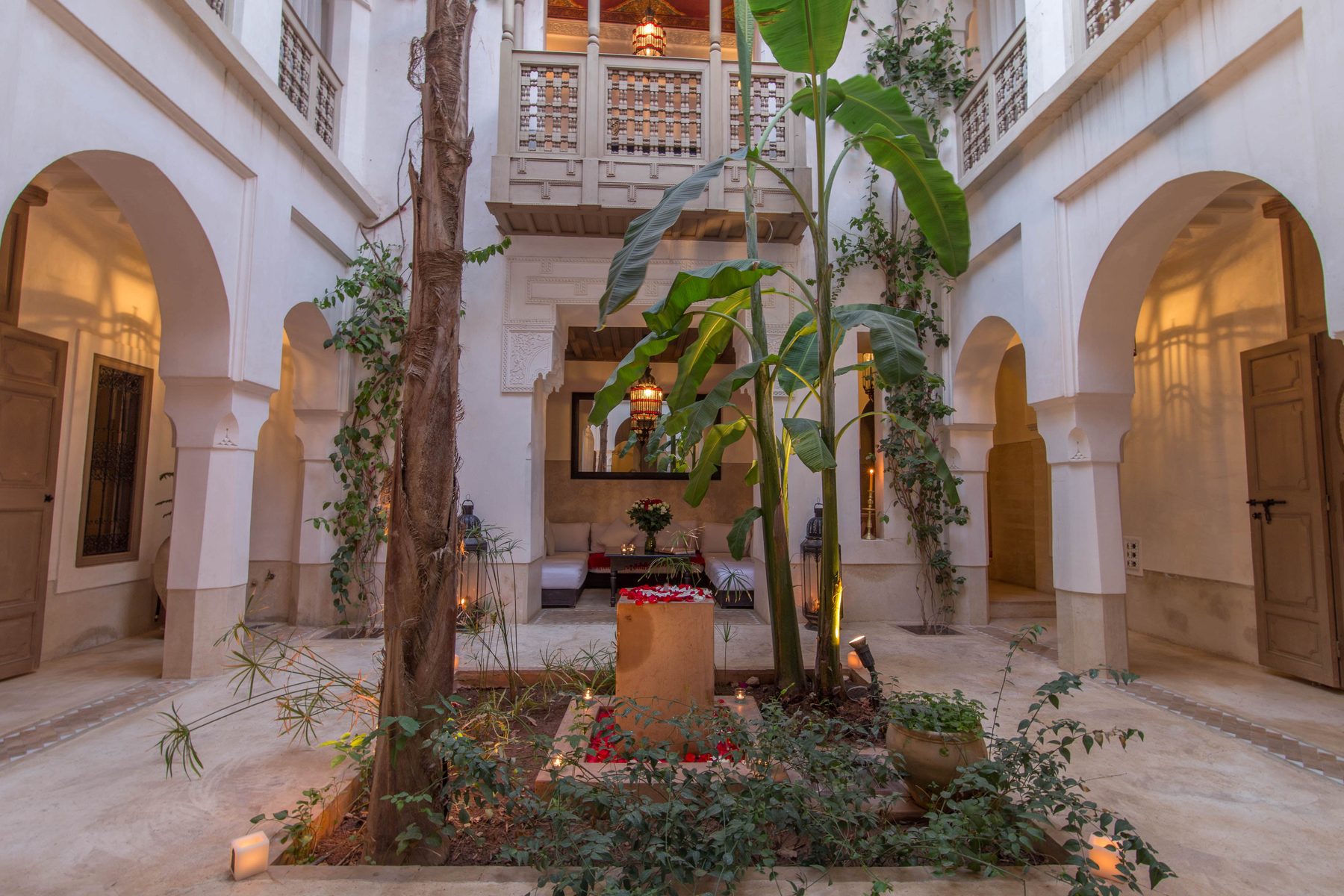 The tree-filled courtyard and white galleries at the heart of Dar Akal
