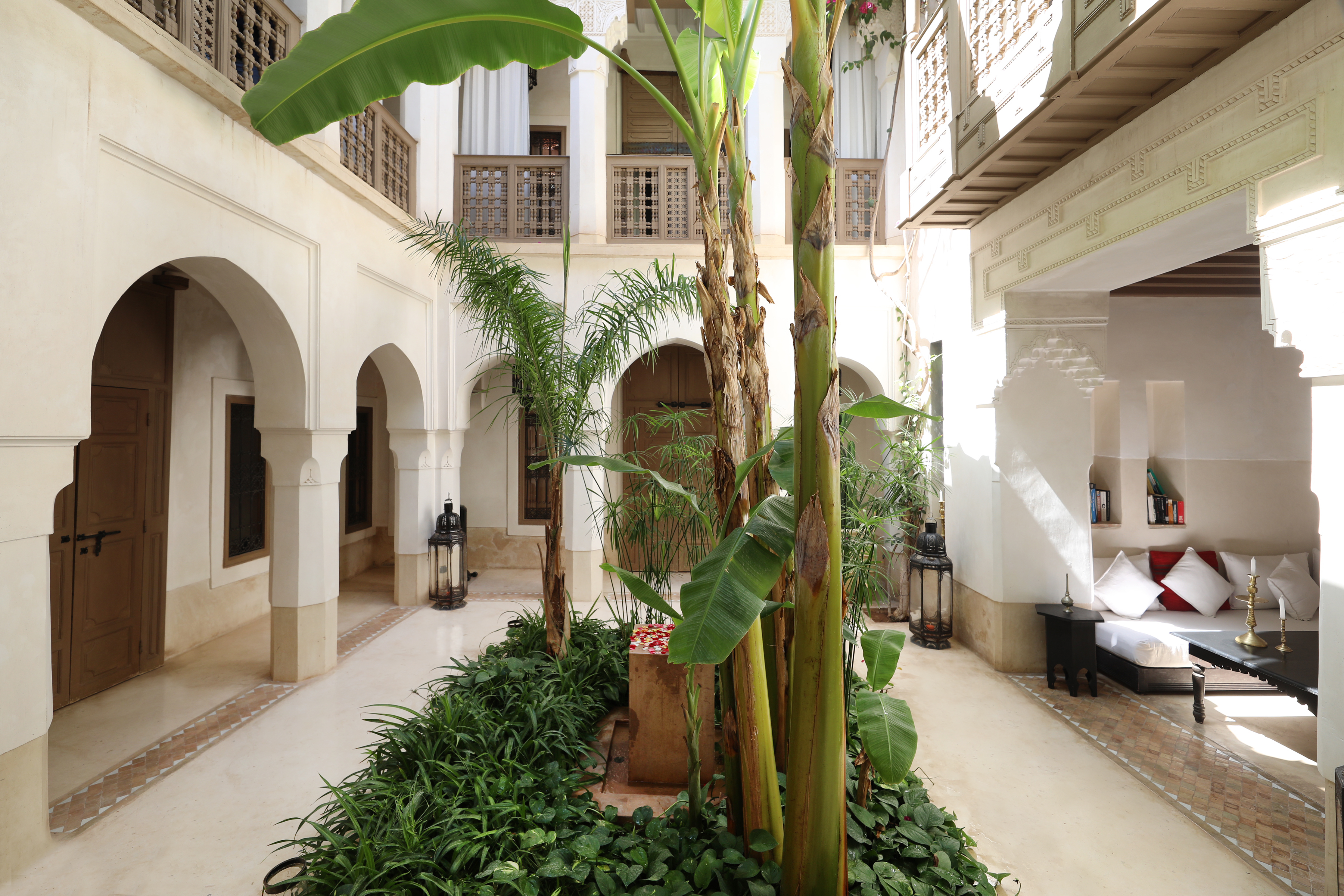 The banana trees, fountain and white galleries in Dar Akal's courtyard