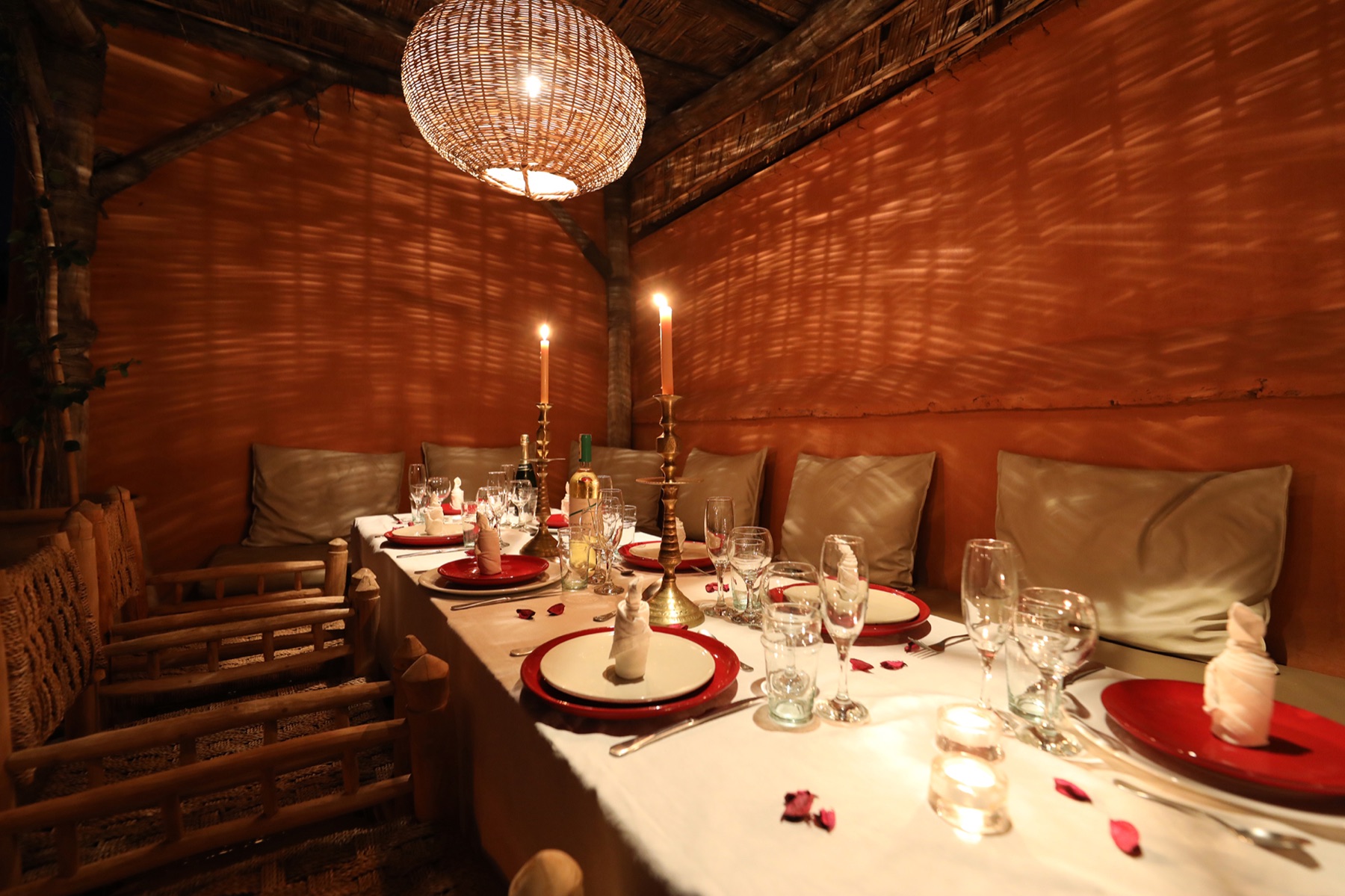 A dinner table prepared beneath the rooftop pergola at Dar Akal